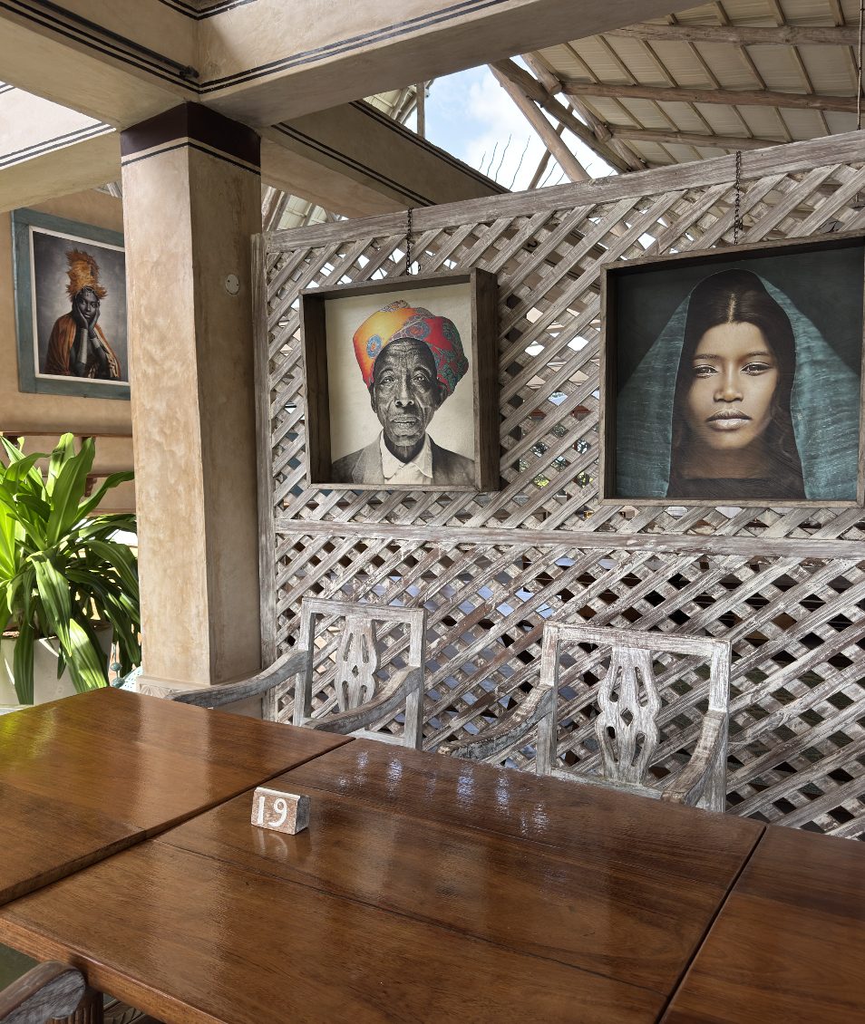 Portraits on a wooden lattice screen in the dining area