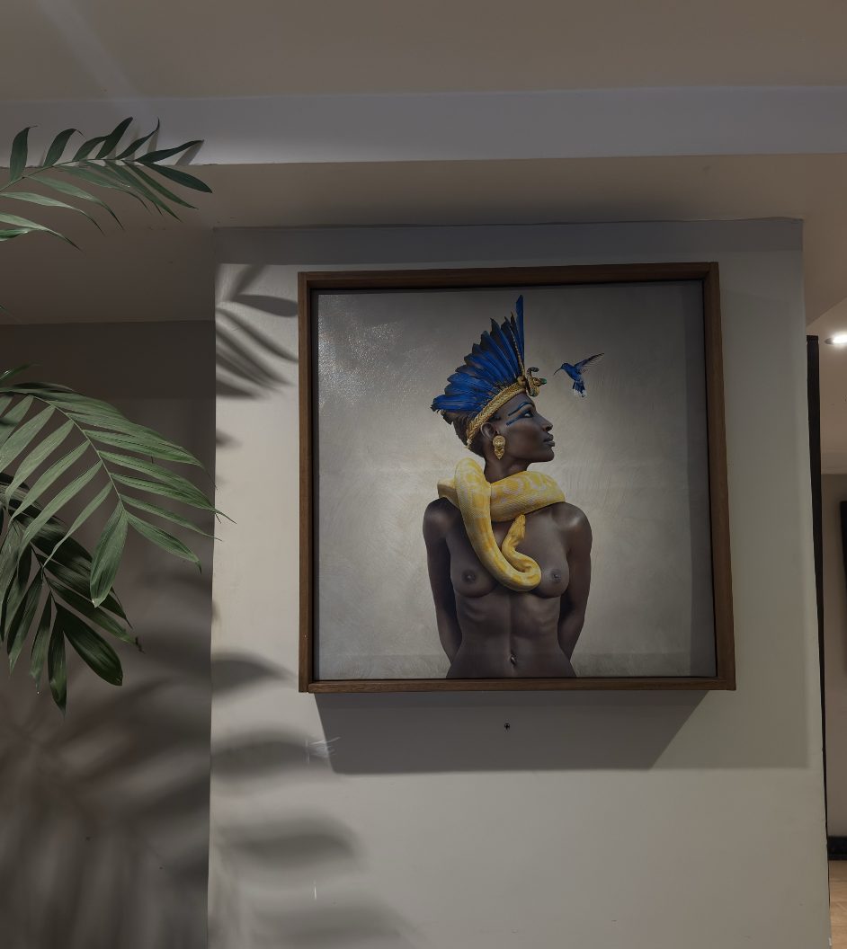 Woman with blue feathers, a yellow python and a hummingbird